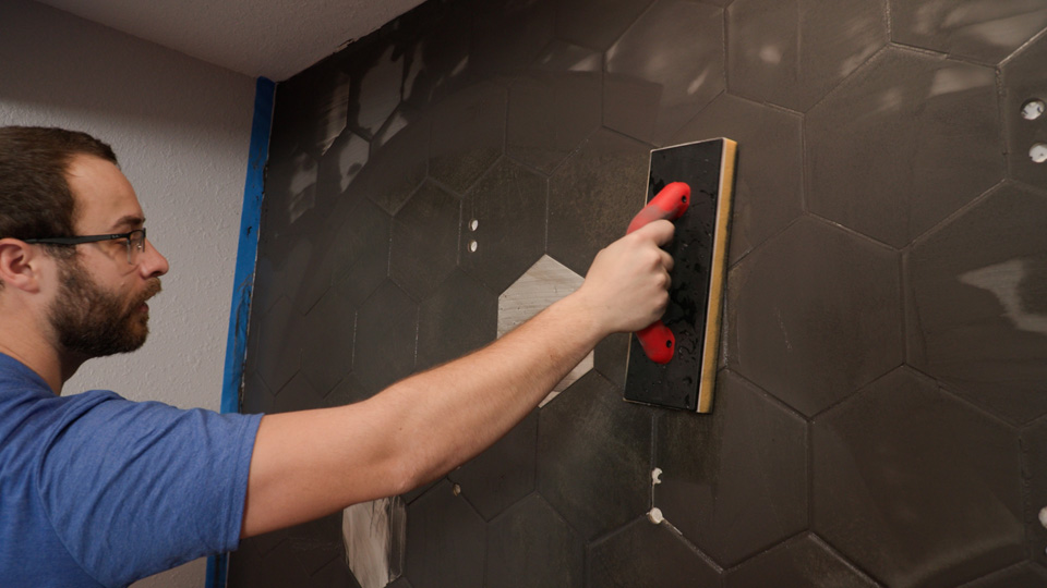 removing the grout from the wall with the Ultra Grouting System sponge